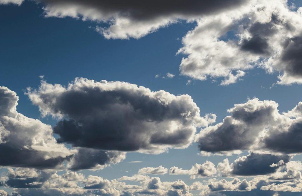 Beautiful cloudscape featuring dramatic clouds against a bright blue sky.