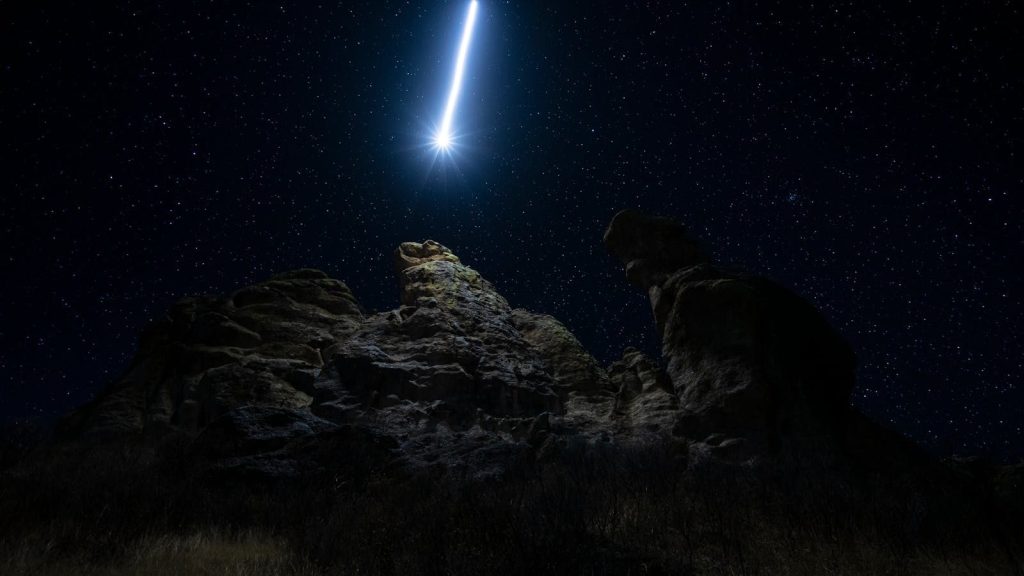 Majestic comet and starry night sky above dramatic rock formations in Durango, Mexico.