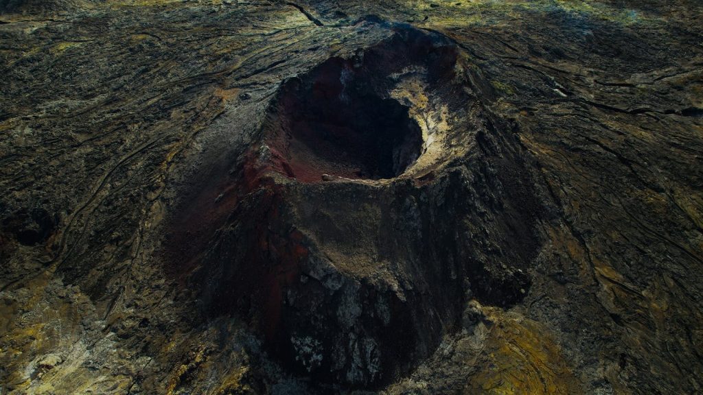 Stunning aerial view of a volcanic crater in Iceland's rugged terrain.
