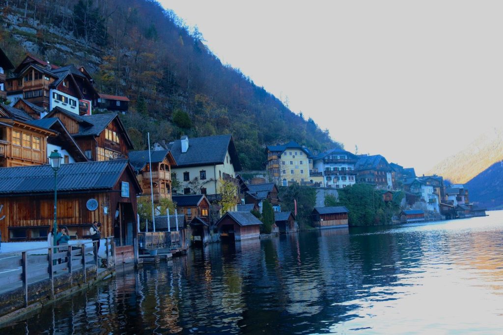 a row of houses on a hill by a body of water