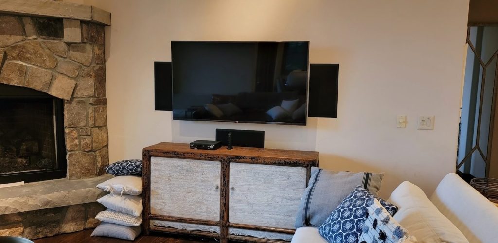 a living room with a fireplace and a flat screen tv