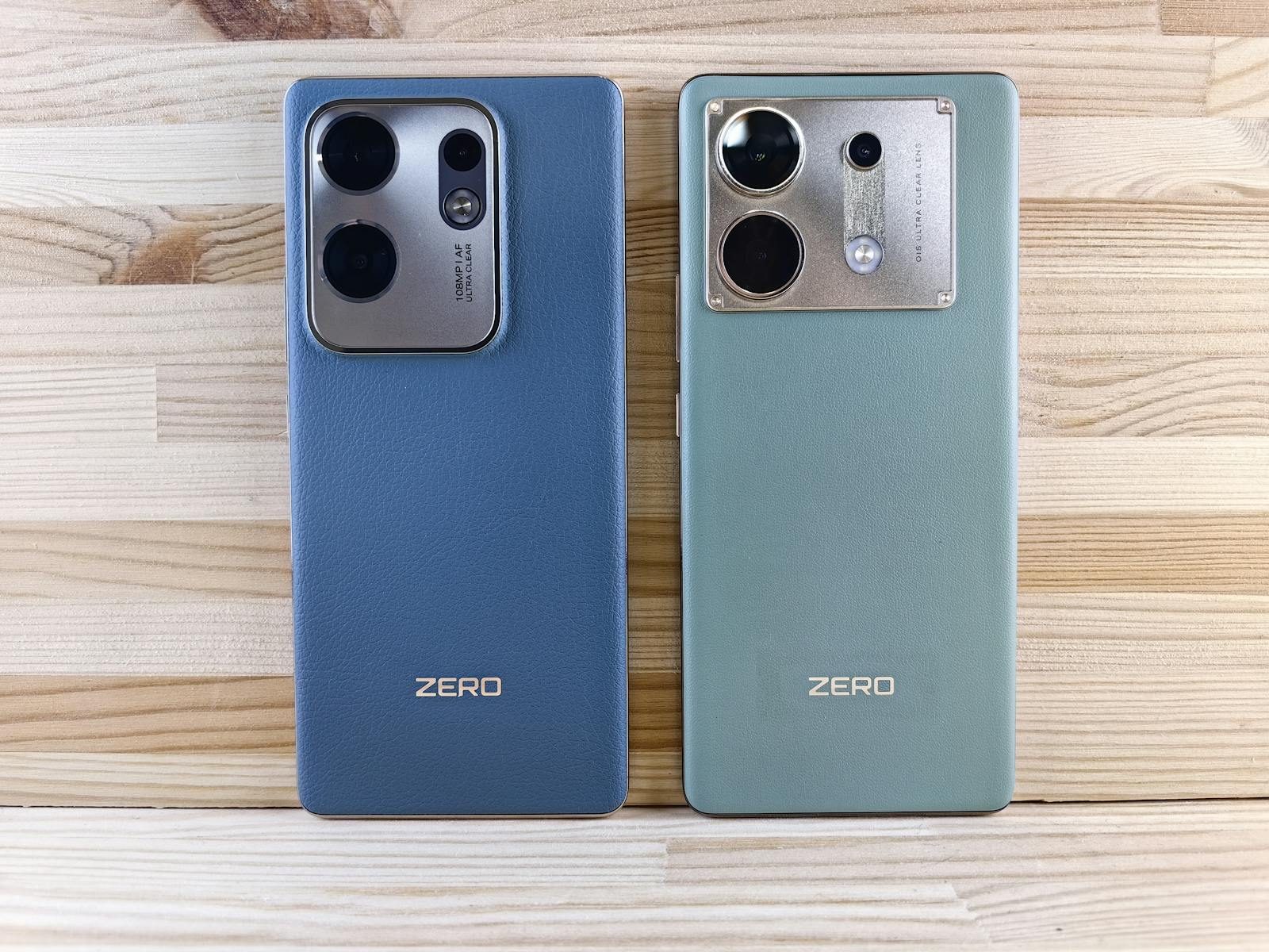 Two smartphones with 'ZERO' branding placed on a wooden surface showcasing their back designs.