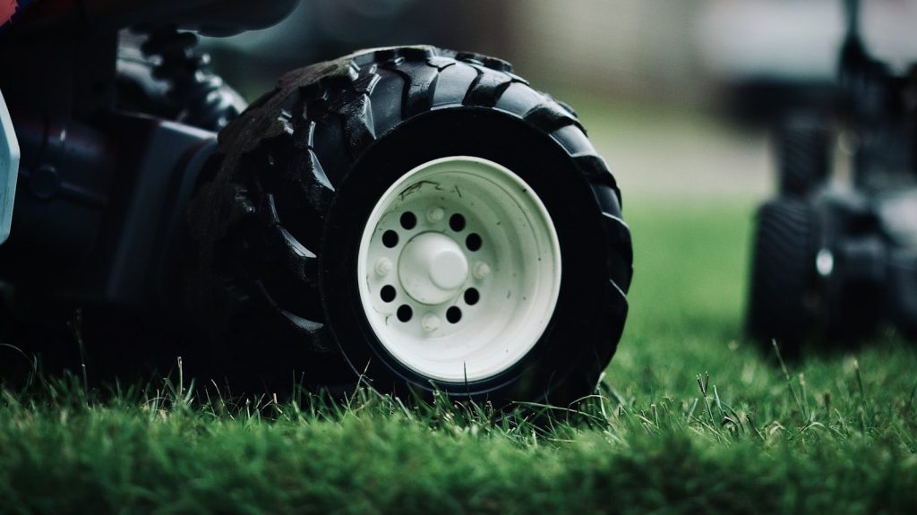white and black wheel on green grass