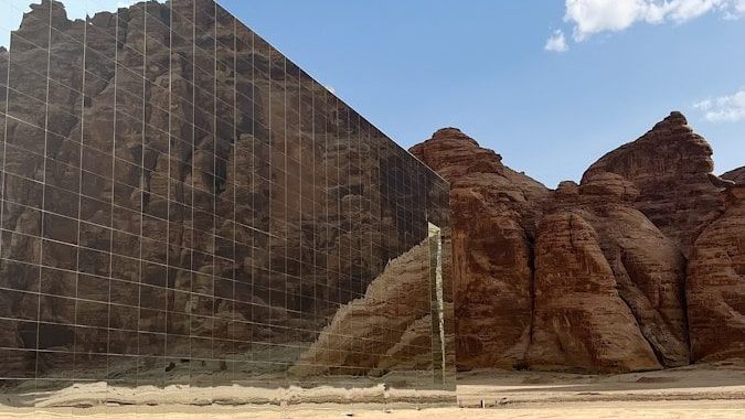 a pyramid in the desert with a sky background
