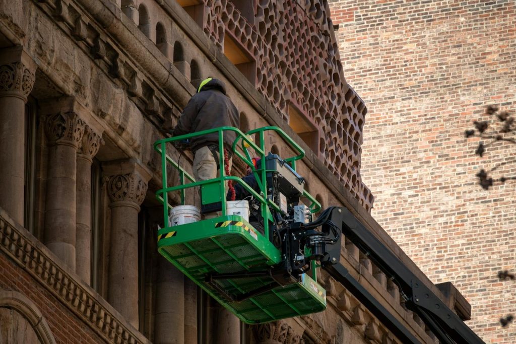 High-rise building restoration project using modern lift equipment.