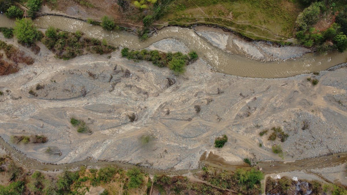 Aerial shot capturing the dry riverbed and terrain in Santa Fé de Antioquia, Colombia.
