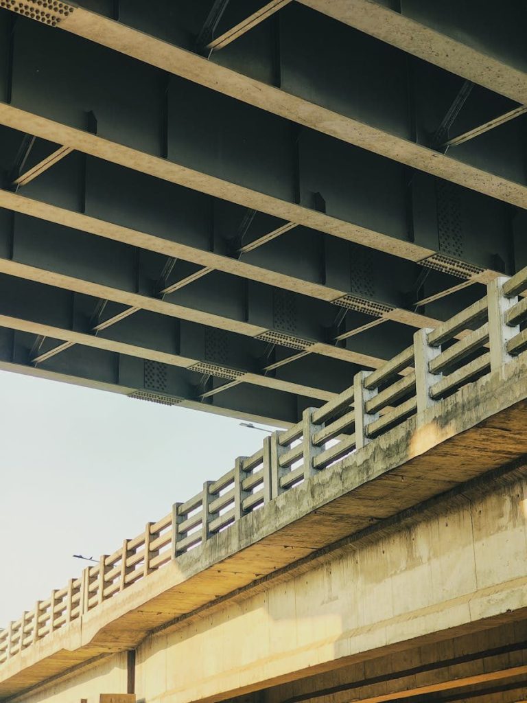 A close-up view of an urban bridge showcasing its architectural design during daylight.