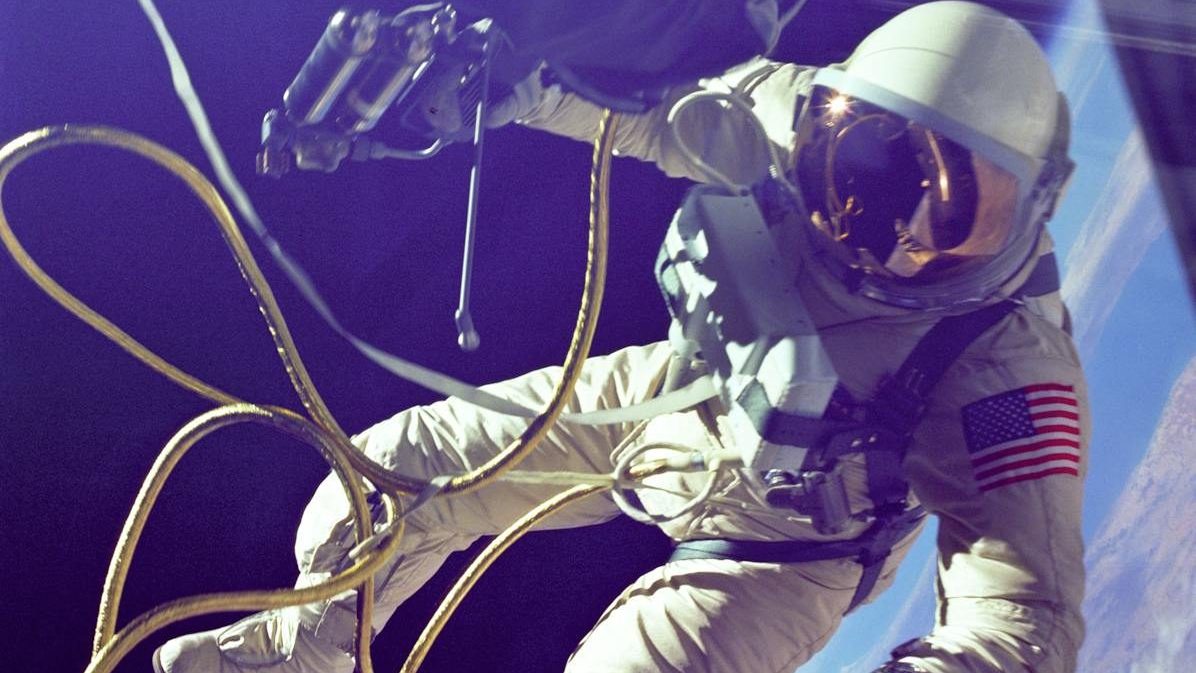 A lone astronaut conducting a spacewalk with Earth visible in the background.