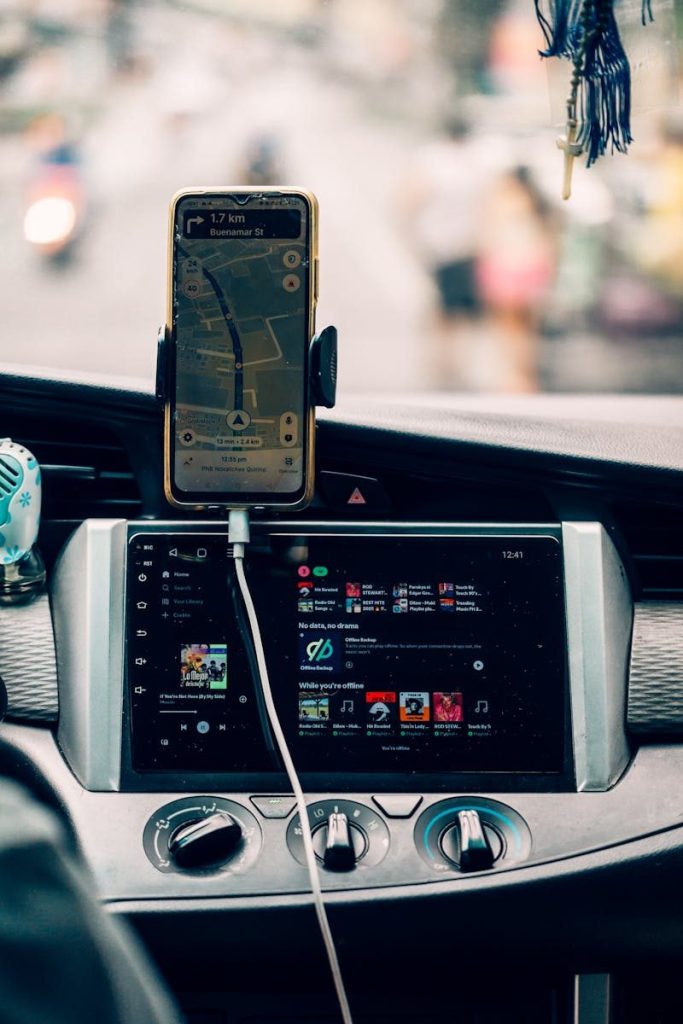 Interior view of car dashboard with GPS and music display, creating a modern travel vibe.