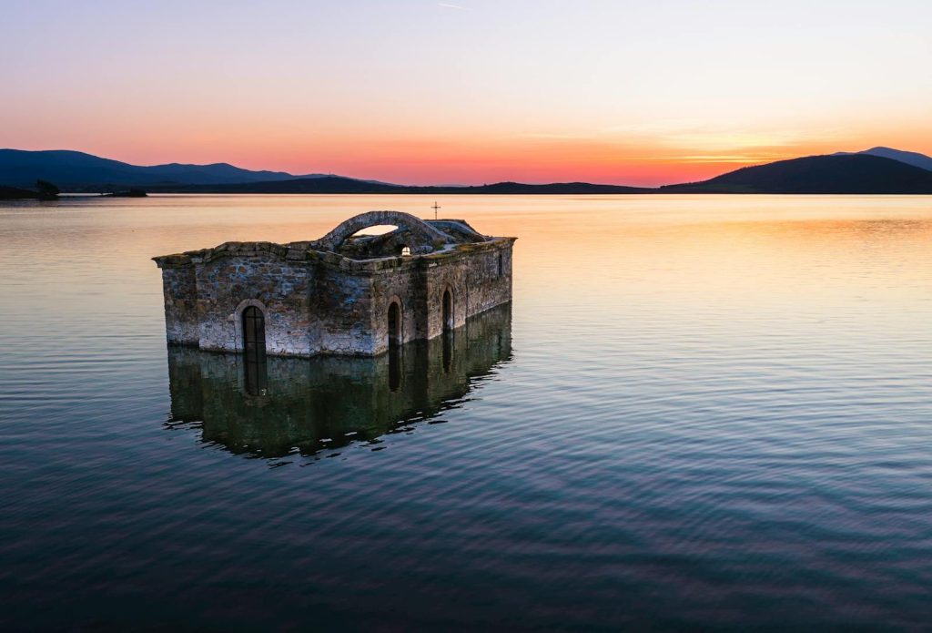 A stunning sunset view of a submerged church in Sliven, Bulgaria.