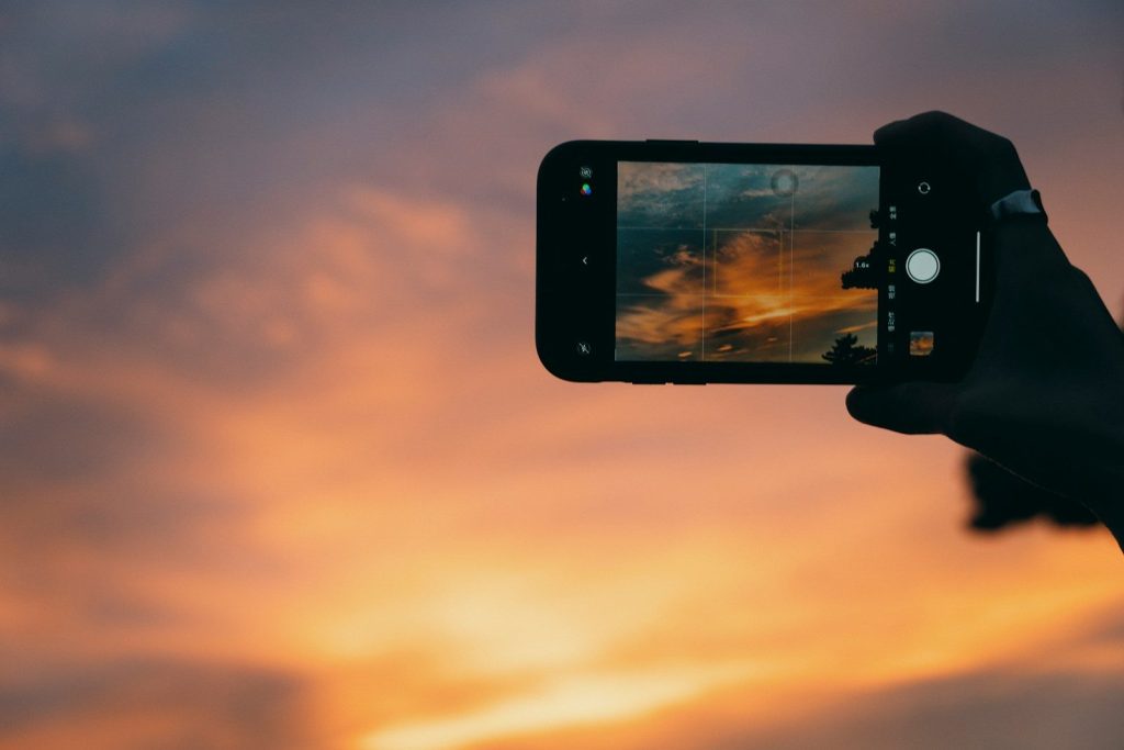 a person taking a picture with a cell phone