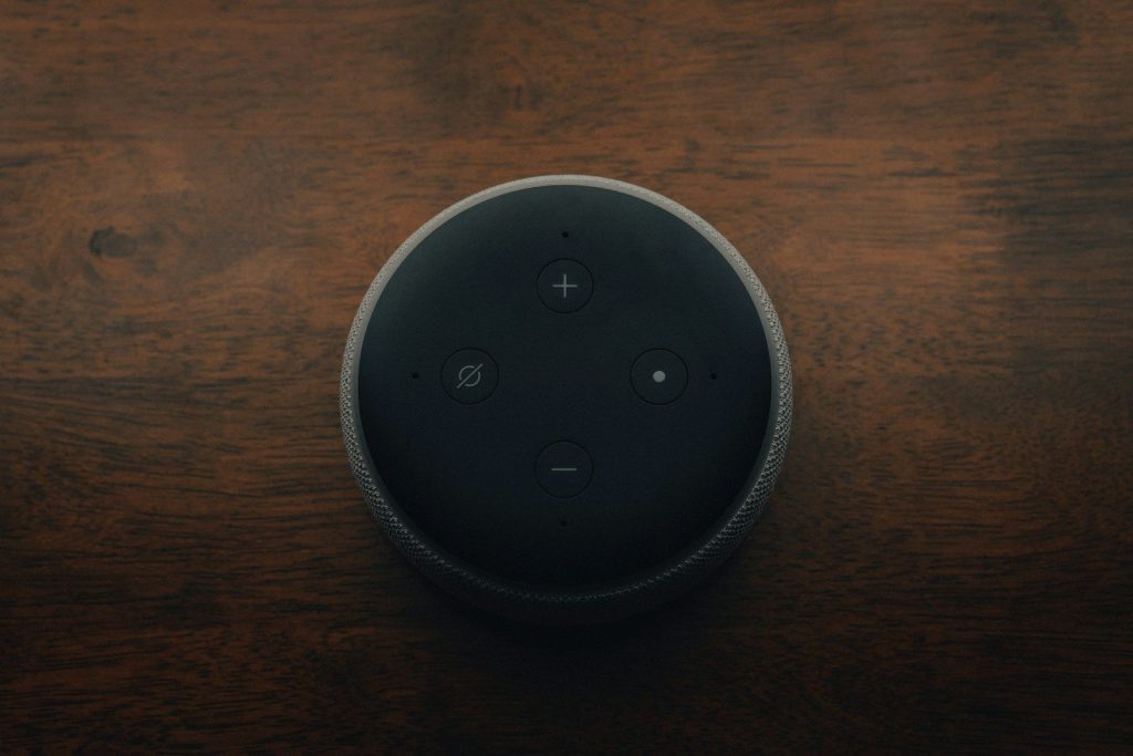 black amazon echo dot on brown wooden table