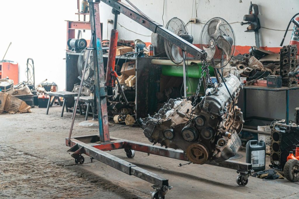 Detailed view of an engine lift in an industrial workshop setting.