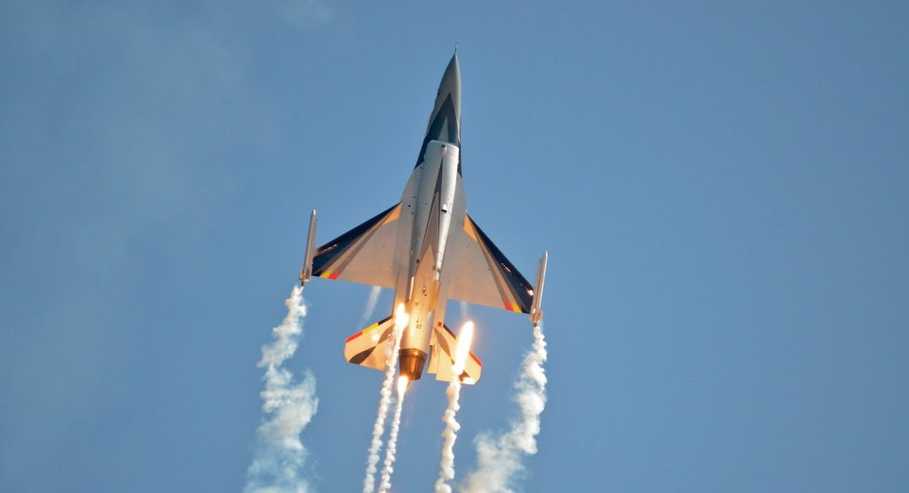 white and black plane in the air during daytime