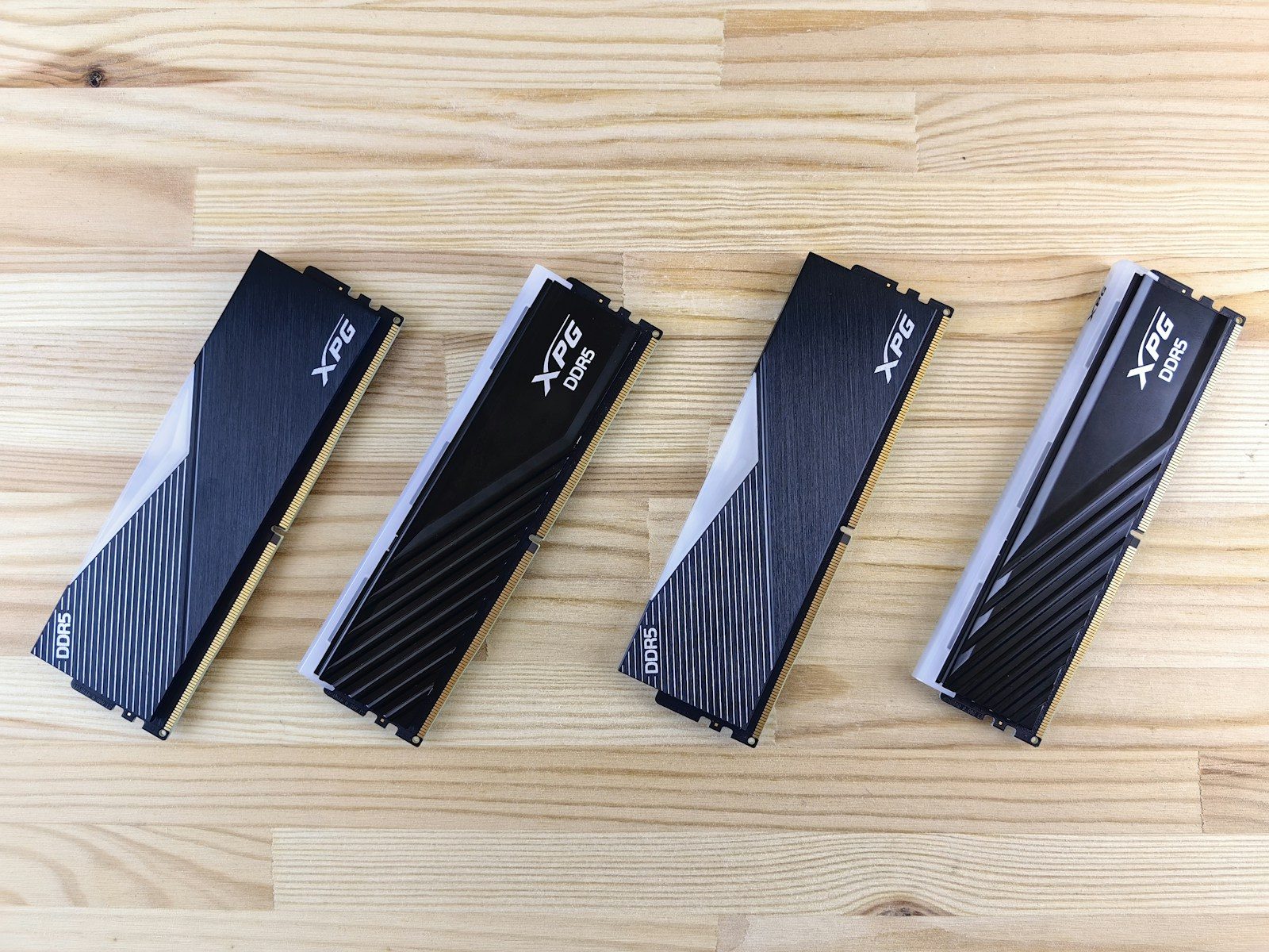 Four computer ram sticks on a wooden surface