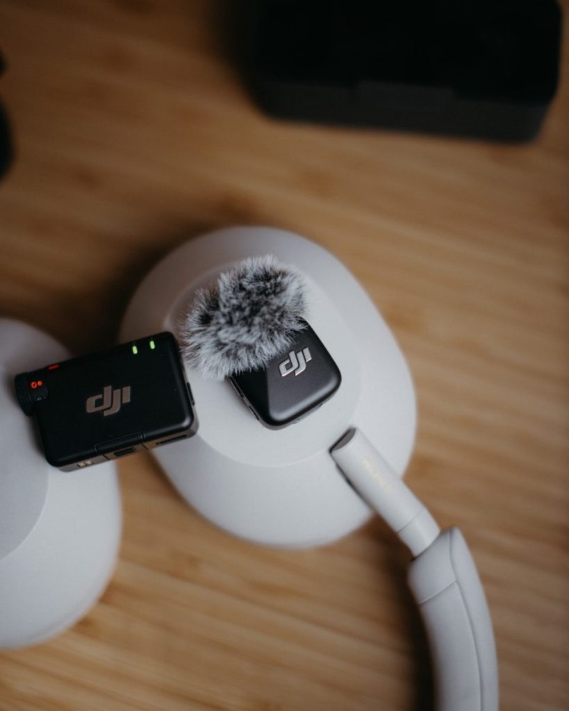 Dji wireless microphones on white headphones