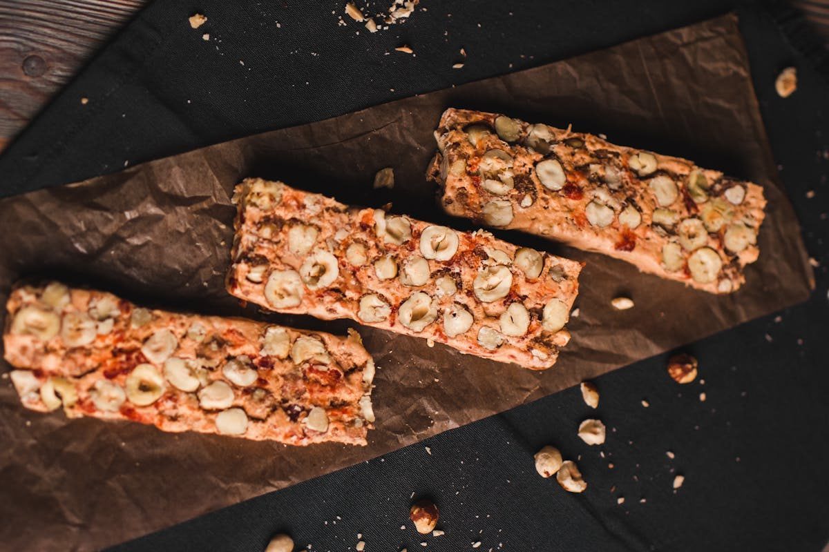 Top view of homemade nut muesli bars on parchment paper, a perfect healthy snack.