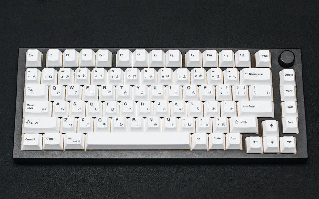 a white computer keyboard sitting on top of a table