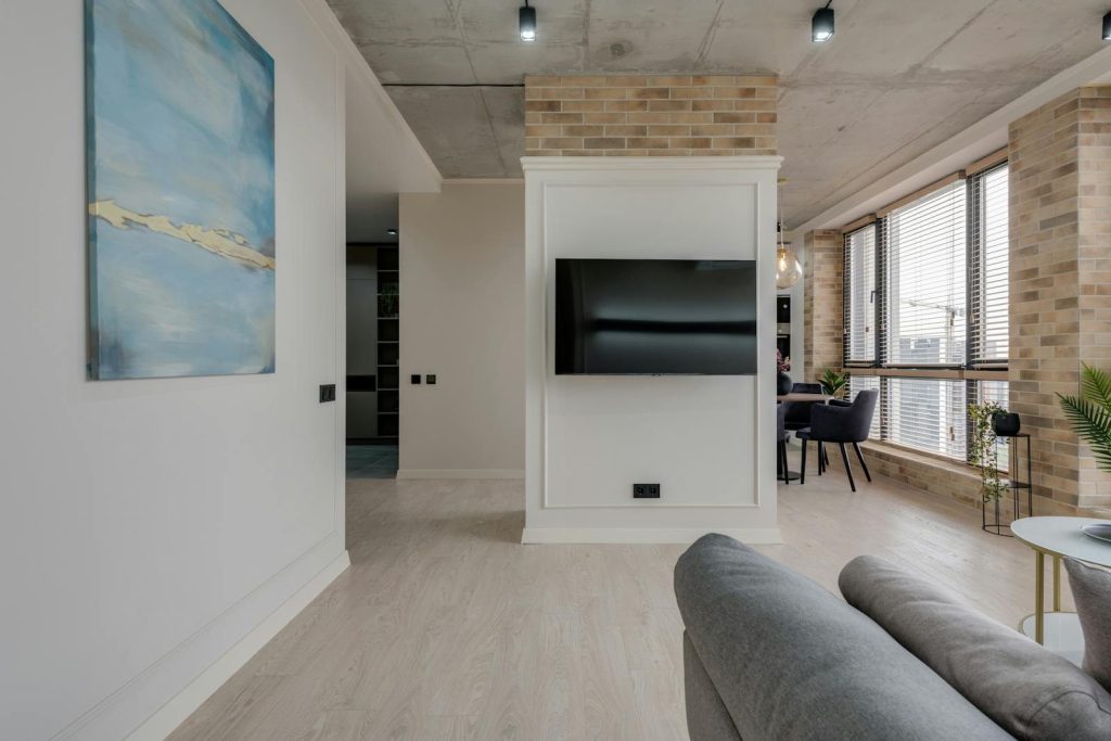 Spacious modern living room with a TV and stylish furniture, offering a cozy home interior vibe.