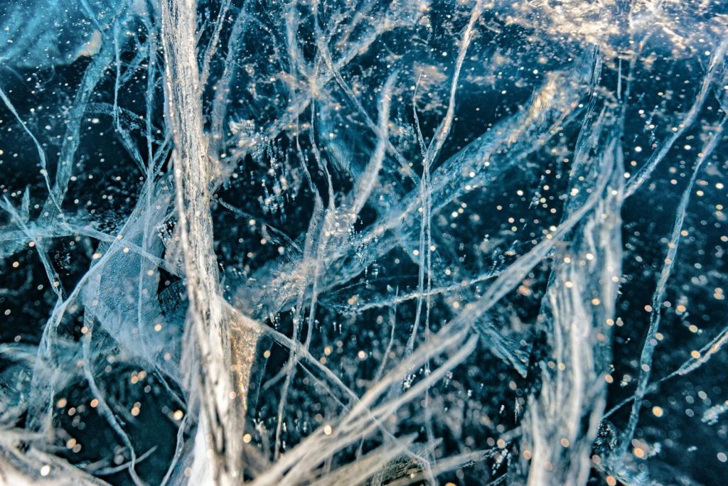 Detailed close-up of intricate ice patterns on Lake Baikal, showcasing unique structures and winter beauty.
