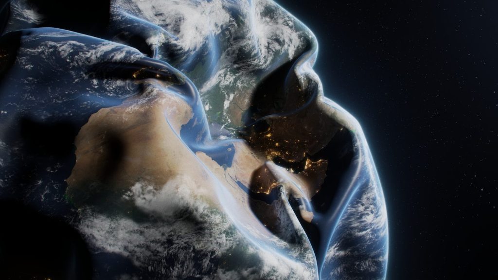 A man in a hoodie with the earth in the background