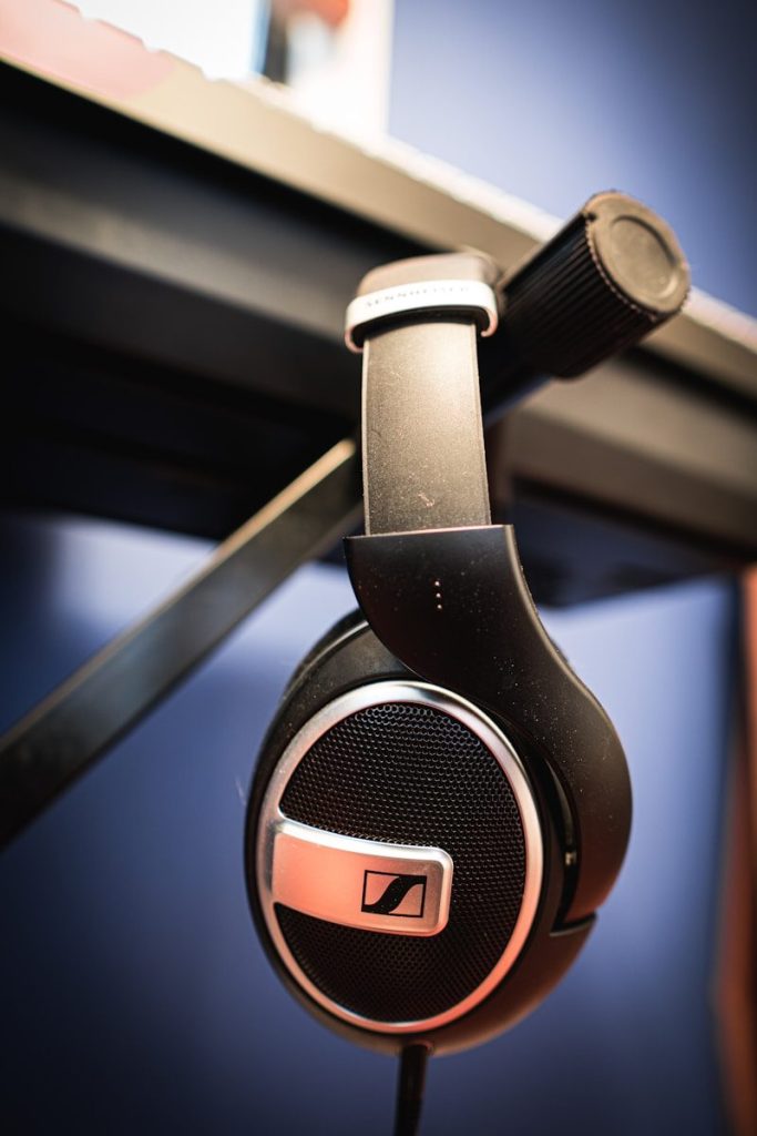 Black headphones hanging from a stand