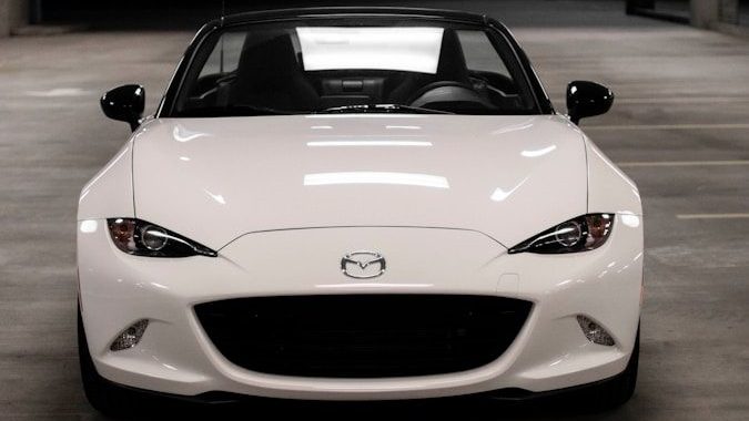 a white sports car parked in a parking garage