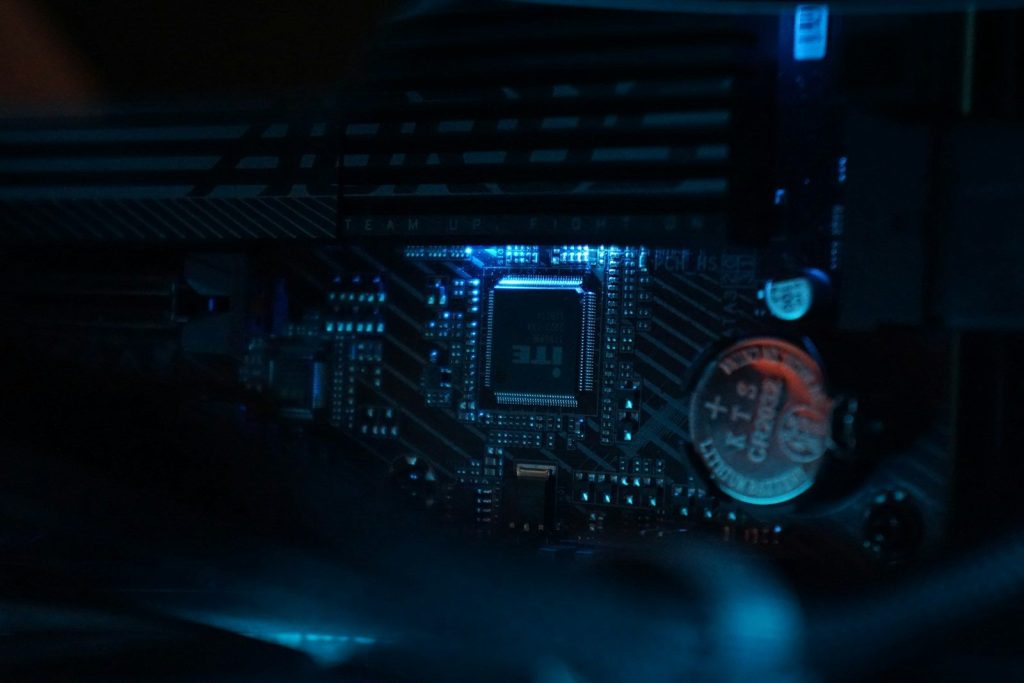 A close up of a computer motherboard in a dark room