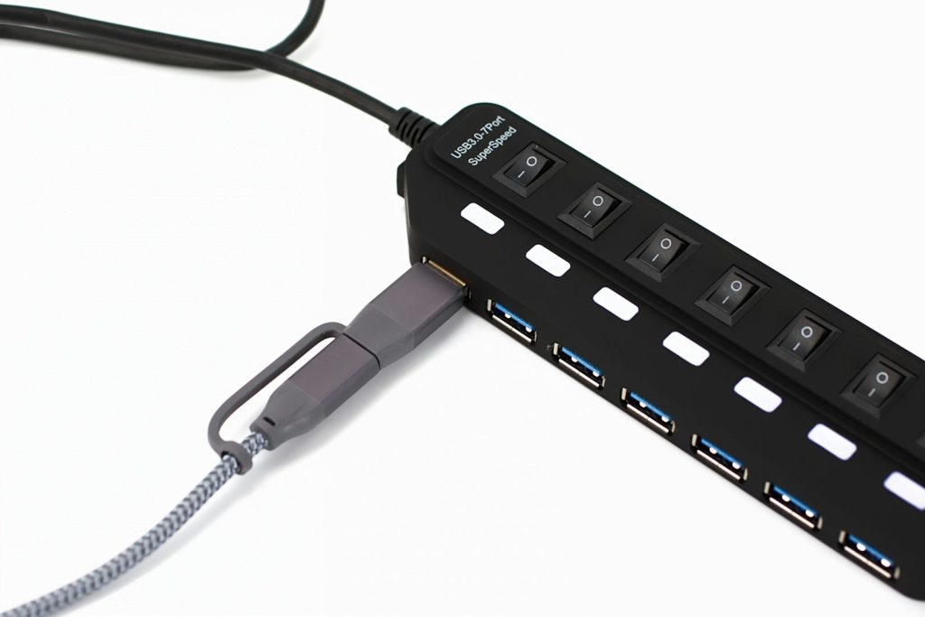Black usb hub with multiple ports and switches.