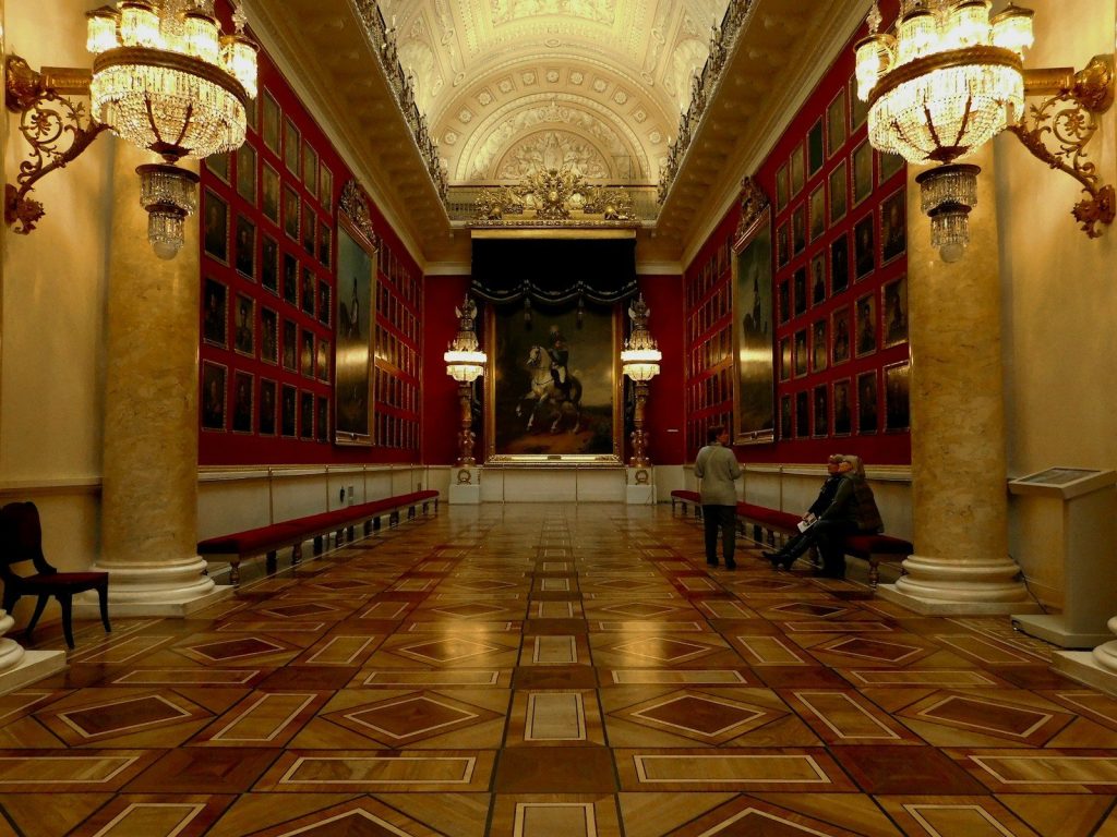 a couple of people sitting on a bench in a room