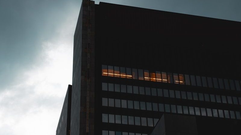a tall building with a cloudy sky