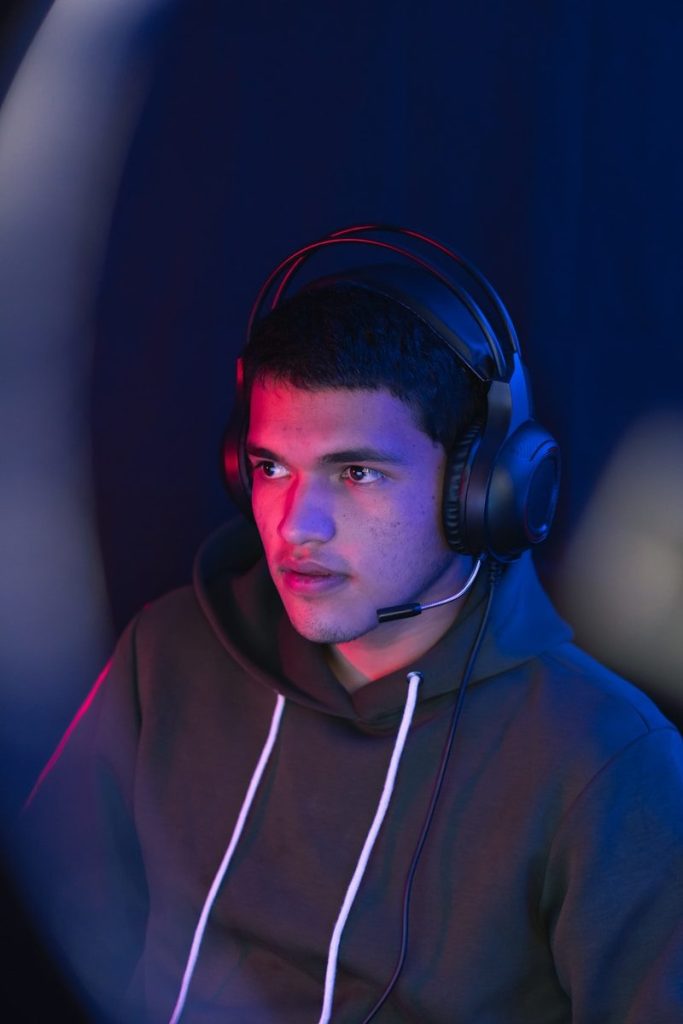 man in blue hoodie wearing black headphones