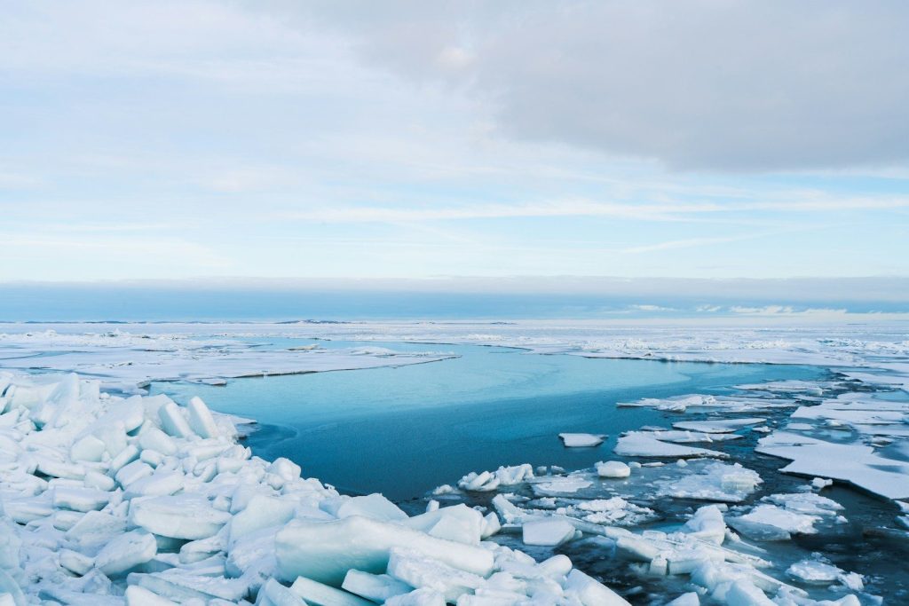 Frozen ocean with patches of blue water