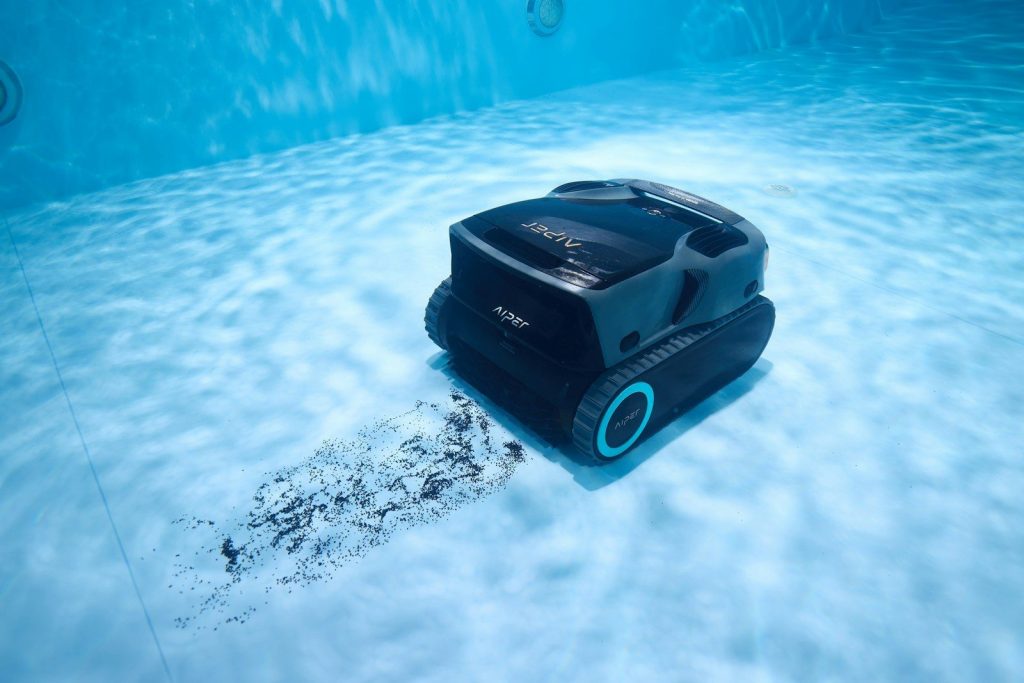 A robotic pool cleaner cleans underwater.