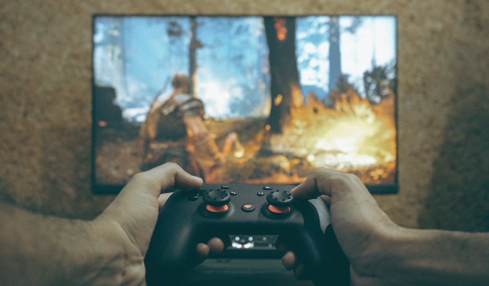 Hands holding a game controller playing a video game.