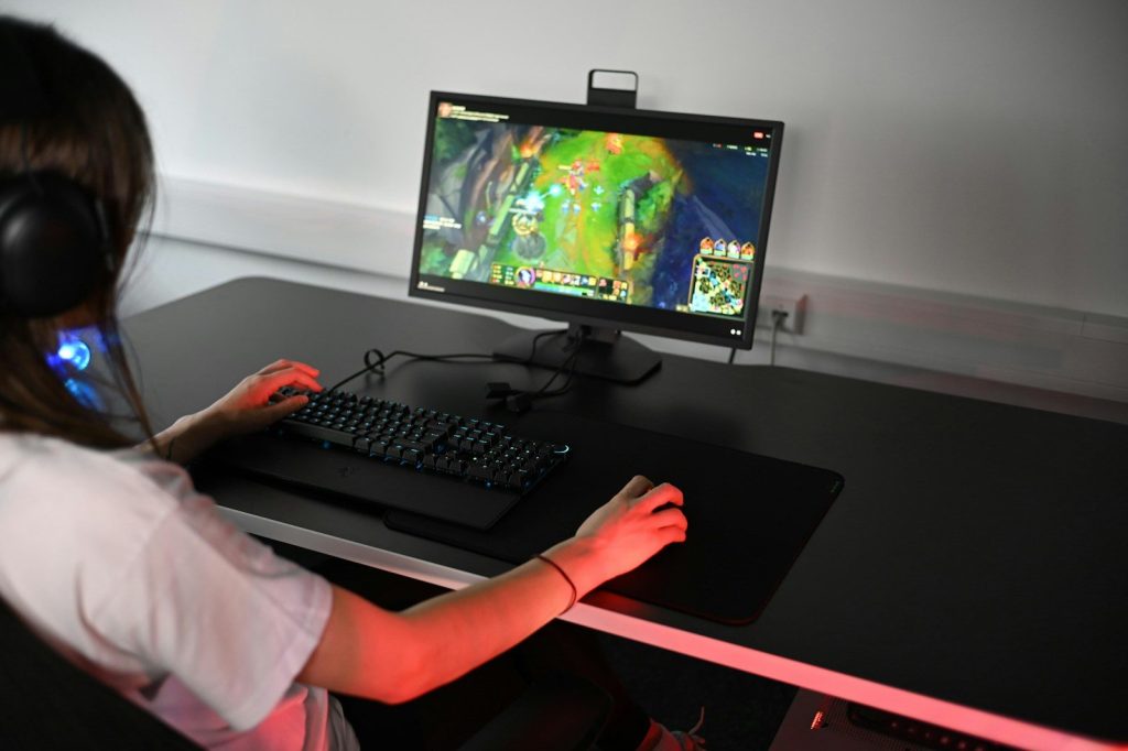 A girl is playing a video game on her computer