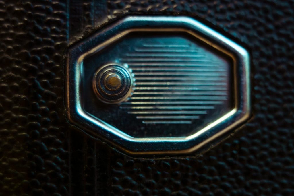Close-up of a vintage camera lens with textured background.