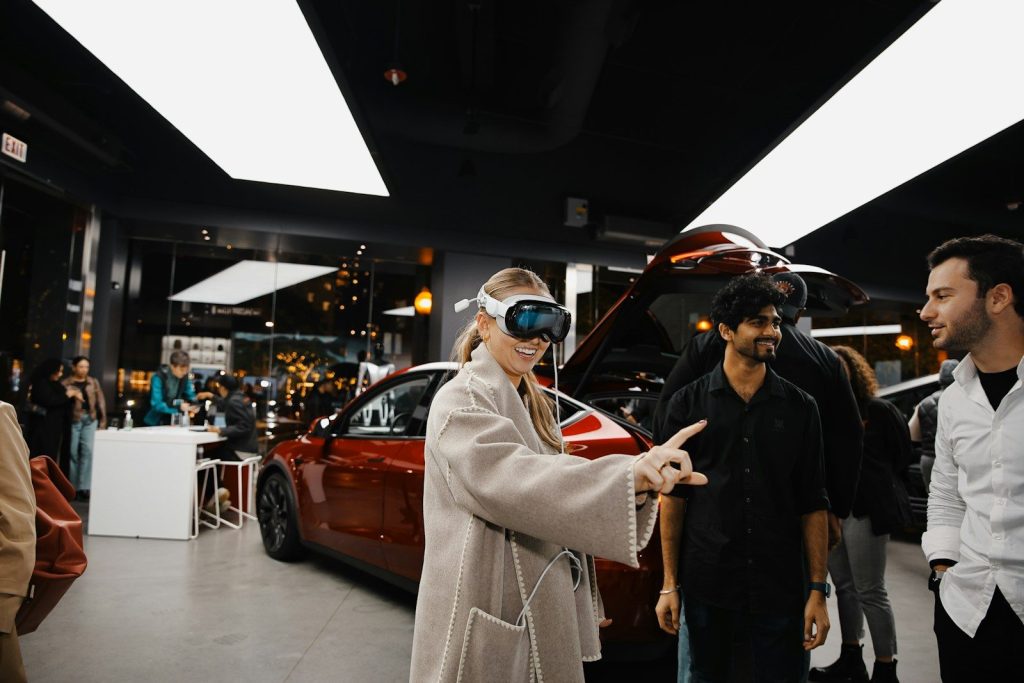 A group of people standing around a car showroom