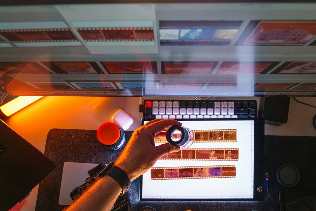 Person examining film negatives on a light table.