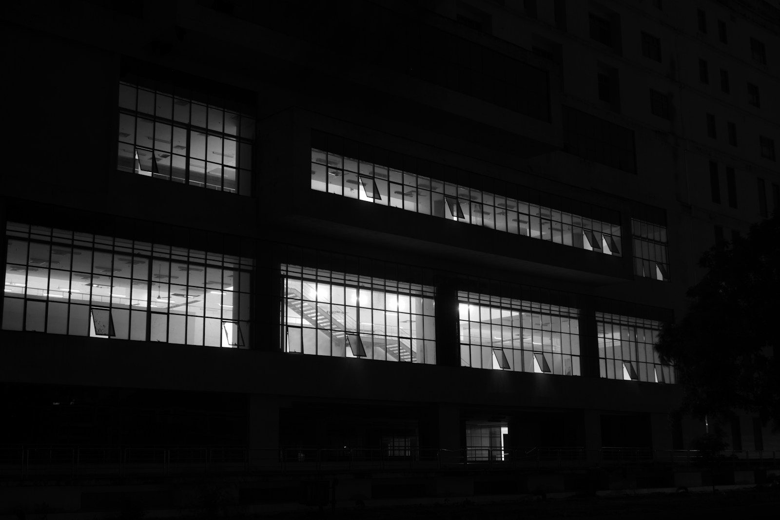 A black and white photo of a building at night