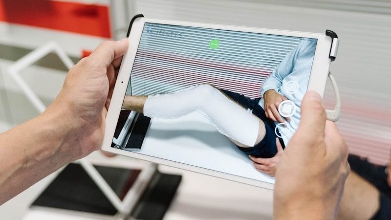 person holding white tablet computer