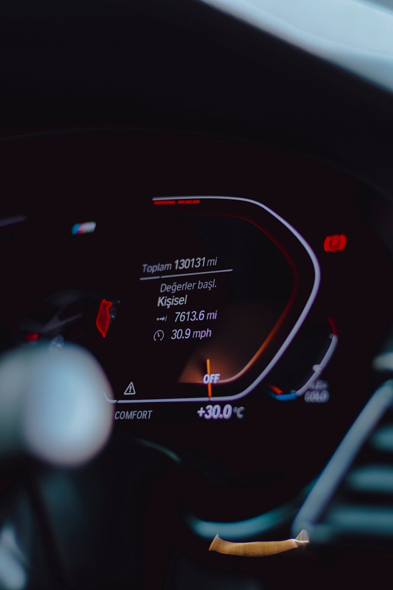 Car dashboard showing mileage and temperature