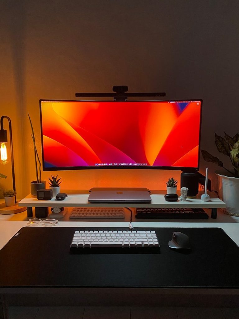 a desk with a monitor, keyboard and mouse