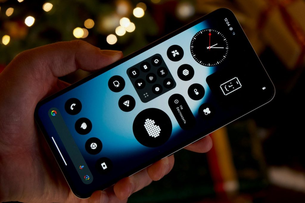 Hand holding smartphone with abstract interface design