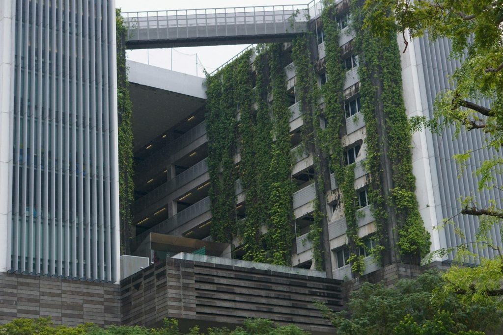Modern building with vertical green gardens and skybridge