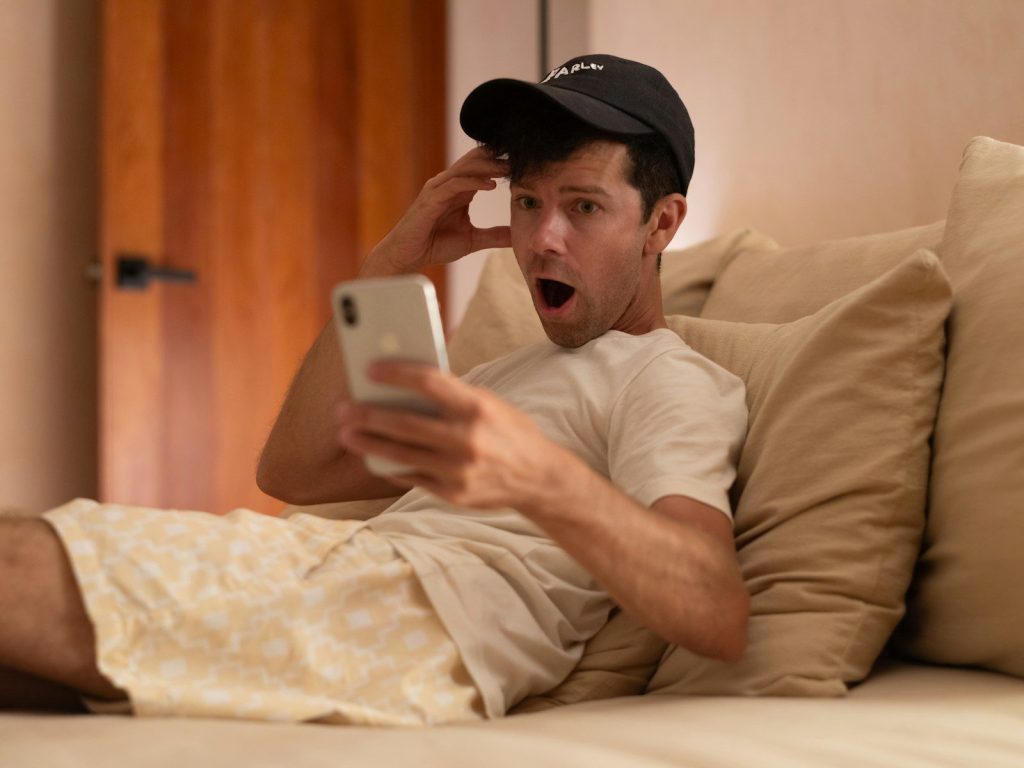 Man is shocked looking at his phone.