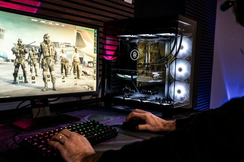 A man is playing a video game on his computer