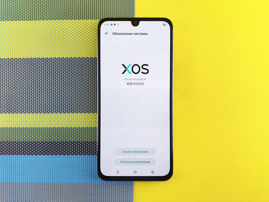 a cell phone sitting on top of a colorful wall