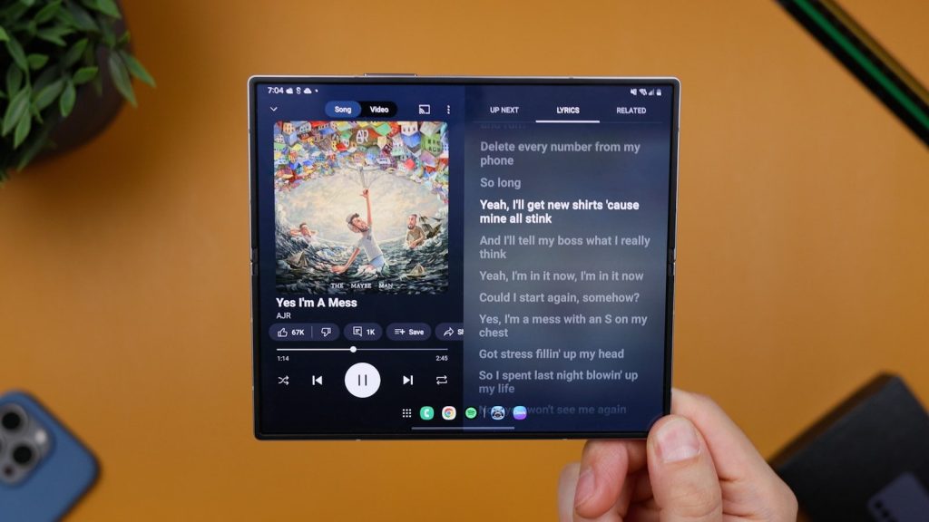 A person holding up a tablet with a picture on it