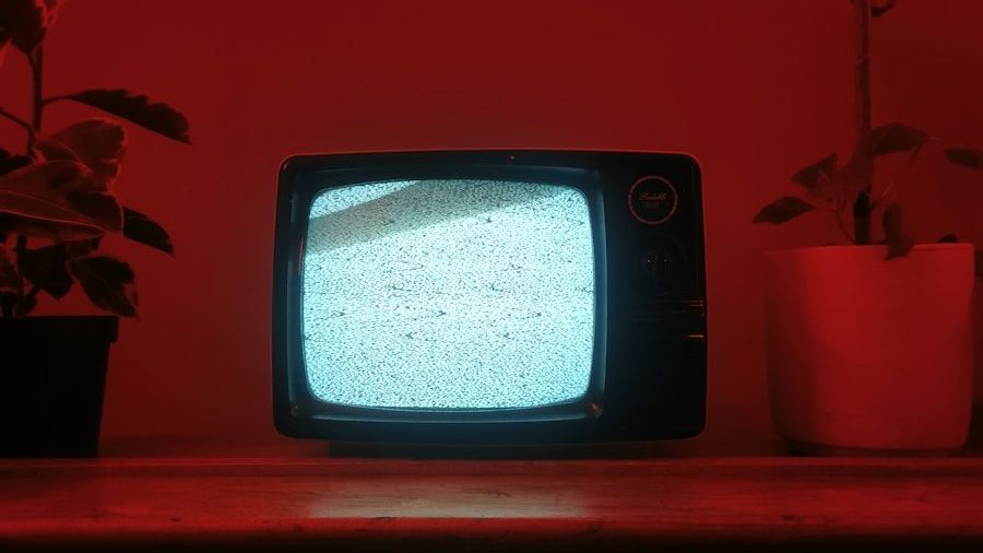a small television sitting on top of a wooden dresser